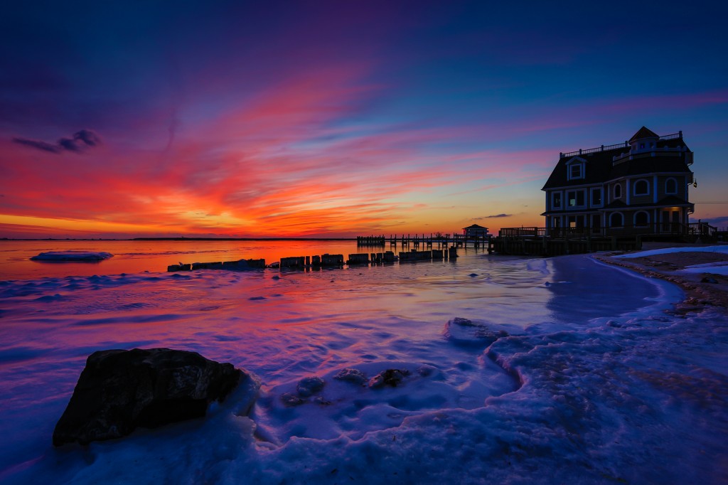 A wide angle HDR photograph of frozen bays and a magnificent sunset at Antoinetta's Restaurant on Cedar Run Dock Road.