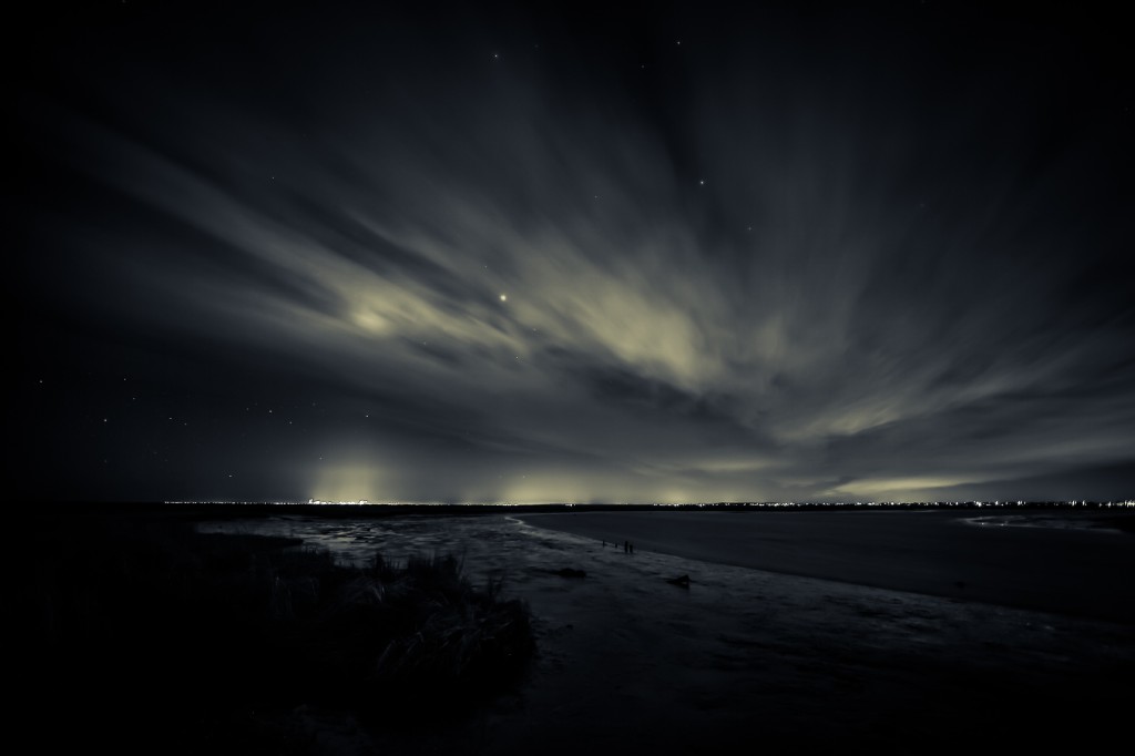 A moody long exposure night photograph overlooking the marshland toward Atlantic City.