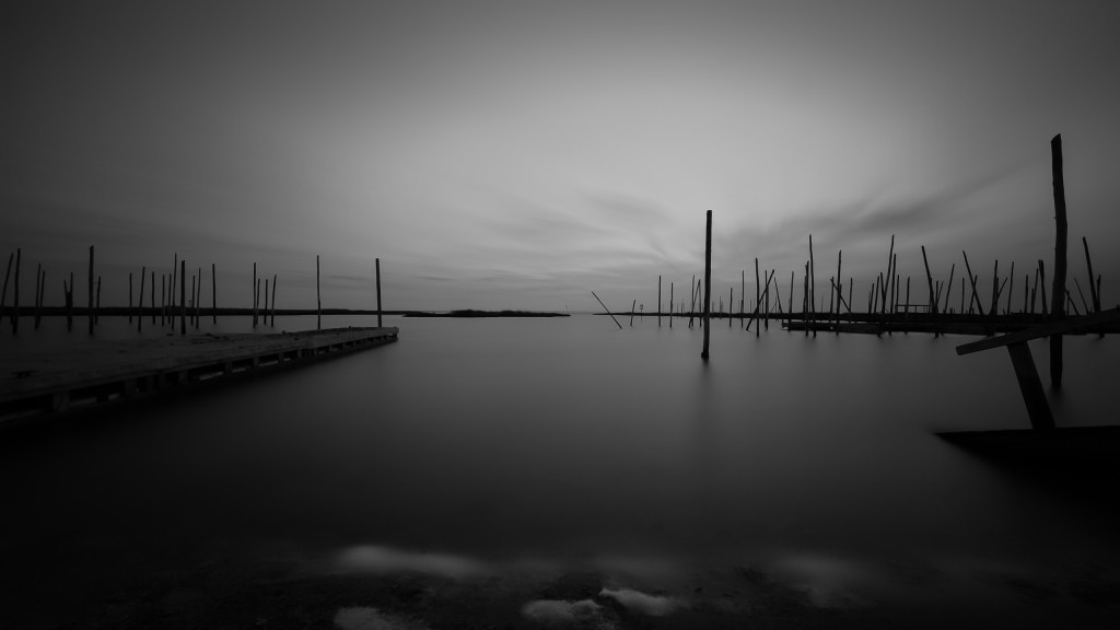 Manahawkin, NJ photographer Greg Molyneux takes a long exposure black and white photograph of the bay and abandoned docks on Great Bay Boulevard.