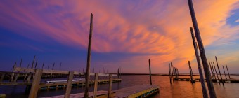 An HDR photograph taken at sunset from Rand's on Great Bay Boulevard featuring an imposing cloud deck backing in off the ocean awash in pinks and purples from the just departed sun.