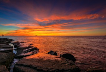 Overlooking a calm Barnegat Bay, this HDR photograph features an unbelievably intense sunset with striking orange, yellow and pink. All backed in a rich turquoise. Taken mere hours before the start of Fall.