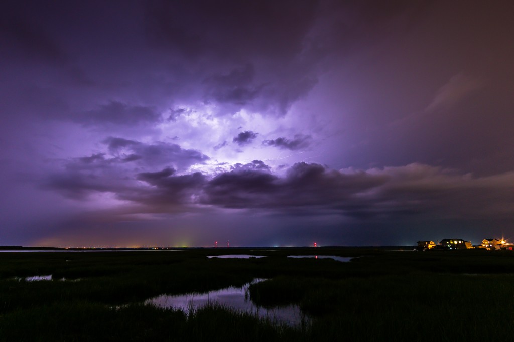 Long exposure lightning photography taken from Cedar Run Dock Road. Cloud to cloud lightning ignites the sky in an electrified purple glow. 