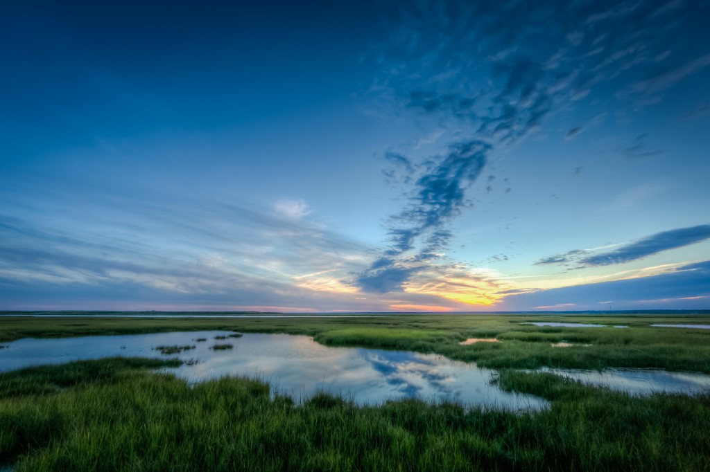 Blue hour in HDR. Taken over Dock Road's southern marsh just after sunset, this photograph features soft tones, cool blues, and understated clouds