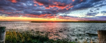 Looking for a dramatic sunset photograph? Here it is, an HDR marsh sunset in all its saturated color glory. Strong shadows and deep contrast are the hallmark of this seascape picture.