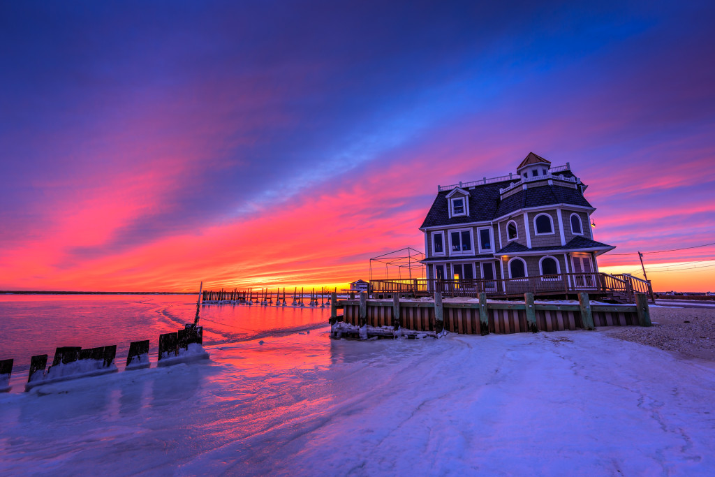 HDR photograph of Antoinetta's Restaurant backdropped by a stunning blue hour over frozen bay and shores.