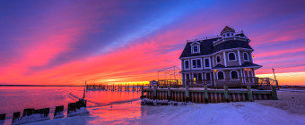 HDR photograph of Antoinetta's Restaurant backdropped by a stunning blue hour over frozen bay and shores.