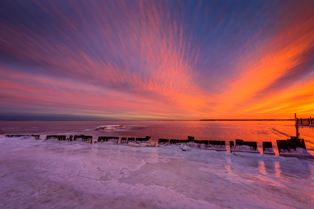 Intense pastels color the undulating clouds in this spectacular HDR sunset photograph over a frozen Barnegat Bay.