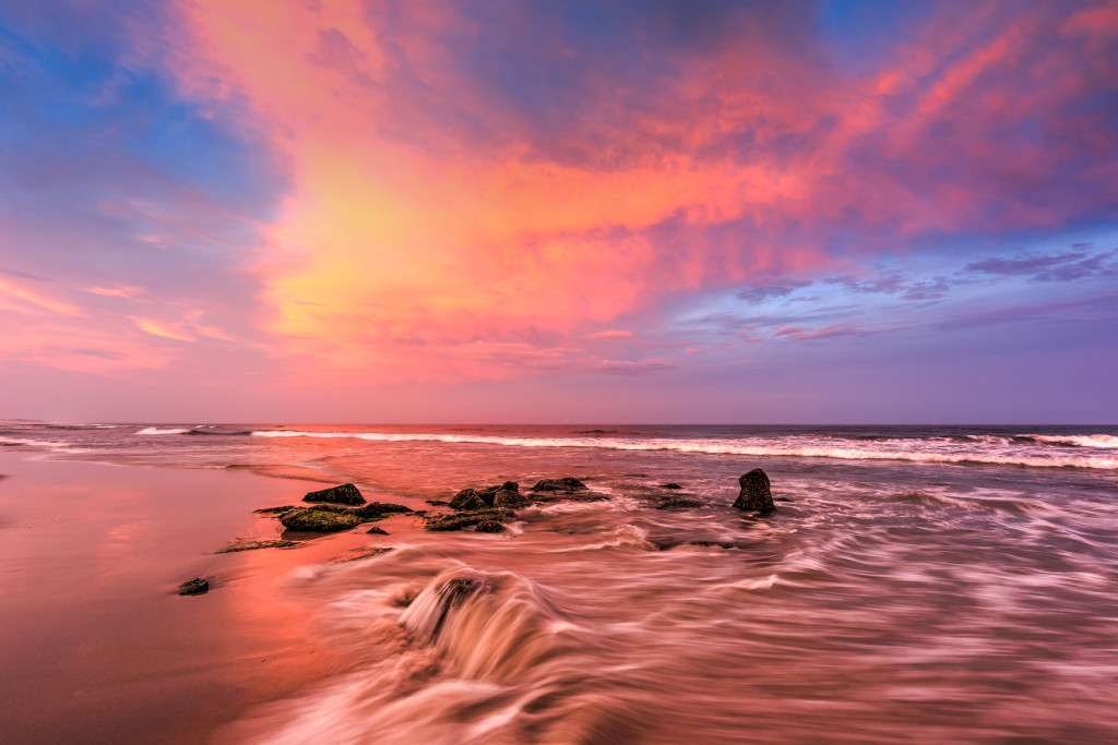 World class sunset over the sandy beaches and jetty rock of Long Beach Island