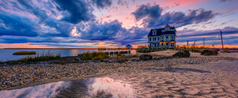Wide angle HDR landscape photograph of ominous clouds backlit by a pastel sunset at Antoinetta's Restaurant