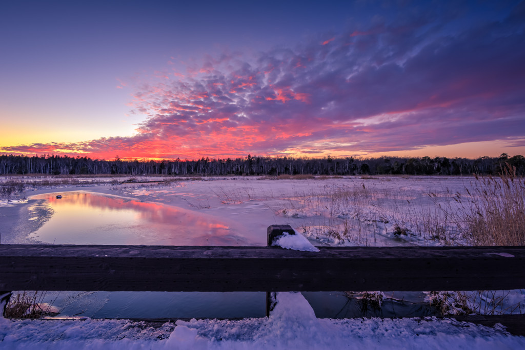 Sunset photograph taken atop a bridge overlooking a frozen marsh a day after Winter Storm Jonas