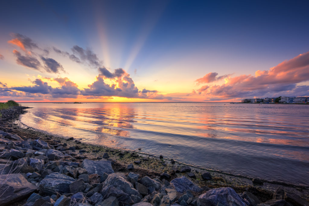 HDR sunset photo with beaming crepuscular rays.