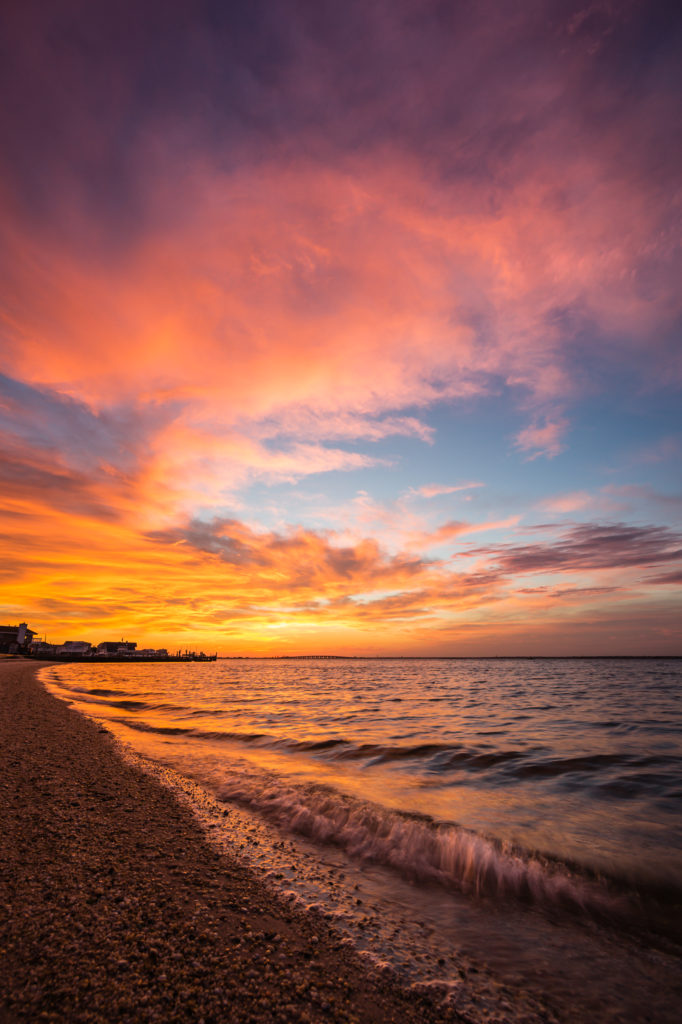 Fiery sunset photograph of explosive cloud color over Barnegat Bay.