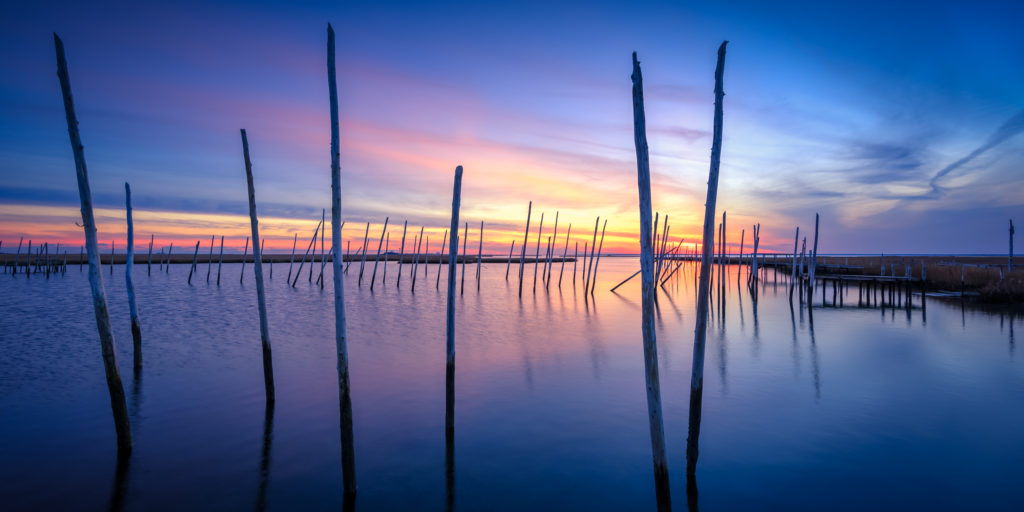 Blue hour HDR photo of a derelict Rand's Marina and cedar poles.
