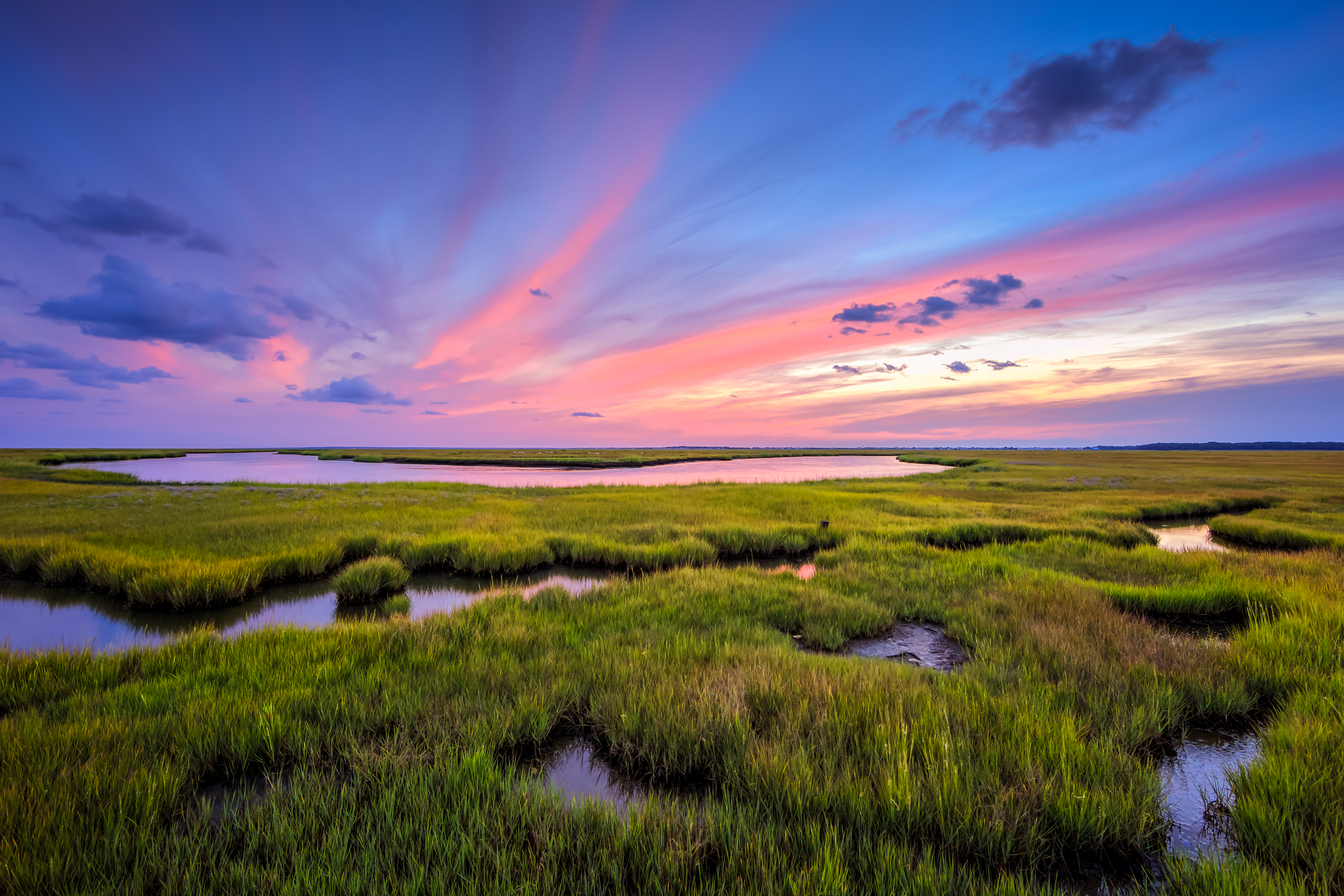 Pastel sunset photo over Great Bay Boulevard Wildlife Management Area's yellowing marsh.