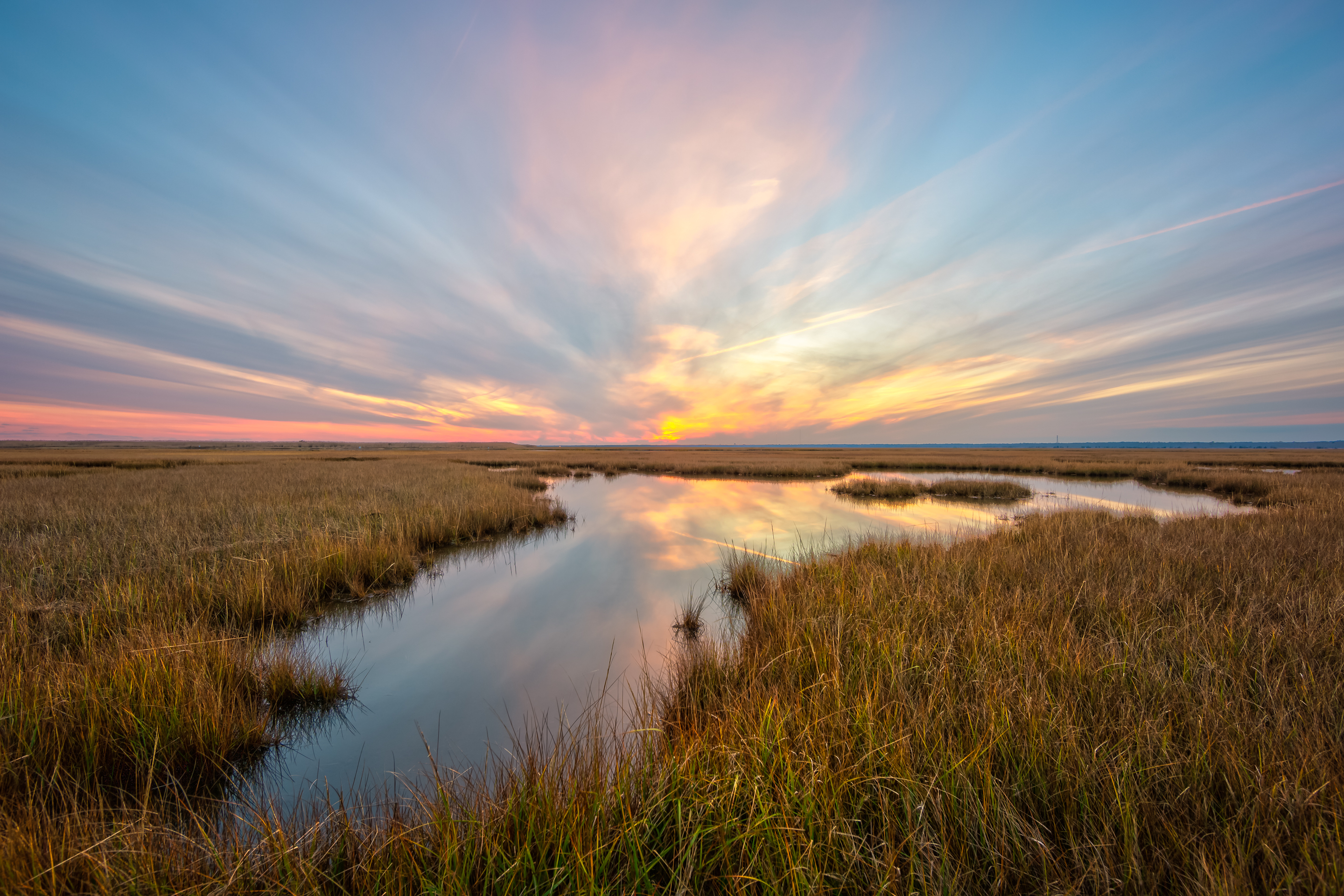 14mm wide angle sunset photo over salt marsh.