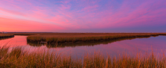 14mm wide angle sunset photo with pastel clouds reflecting in an oxbow lake in the Cedar Run Dock Road salt marsh.
