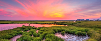 14mm wide angle photograph of a stunning sunset with pastel colored clouds sweeping across the Cedar Run Dock Road salt marsh.