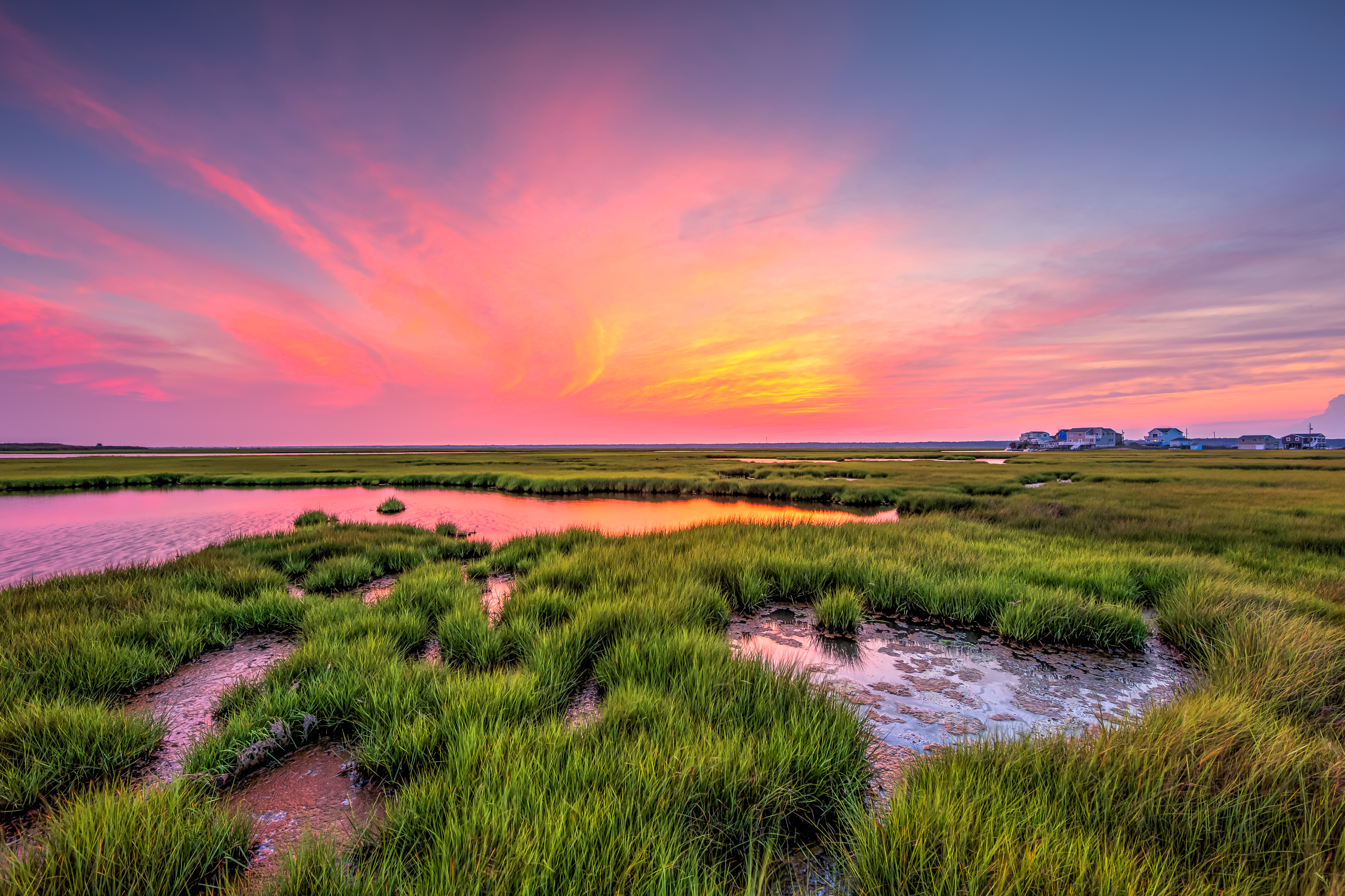 14mm wide angle photograph of a stunning sunset with pastel colored clouds sweeping across the Cedar Run Dock Road salt marsh.