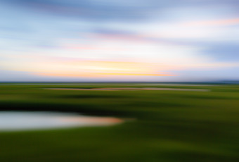 35mm out of focus photo of Cedar Run Dock Road salt marsh made with motion blur by panning the camera left to right.