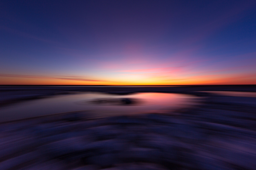 14mm blue hour photo using panning motion blur to create a dark, painterly effect of Cedar Run Dock Road salt marsh.