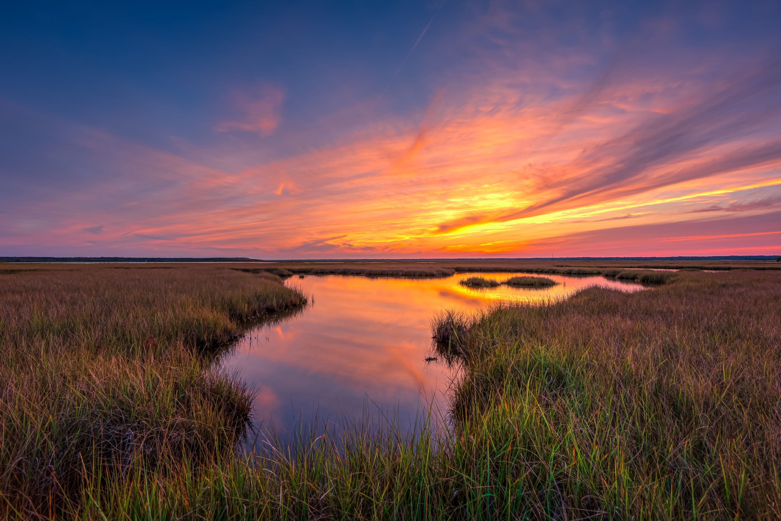 14mm HDR photo of a sunset over Cedar Run Dock Road's salt marsh. Tropical Storm Ophelia spun overrunning cirrus clouds as the storm's outer bands approached the mid-Atlantic coast.