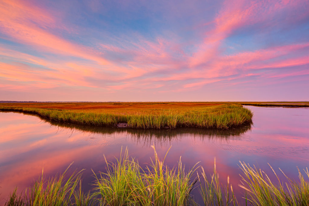 14mm wide angle HDR sunset packed with cotton candy pastel clouds reflected over the late summer salt marsh.