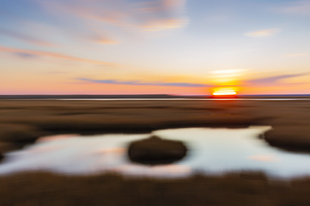 35mm sunset photo taken at Cedar Run Dock Road salt marsh. South facing exposure panning left to right creates smooth motion blur across the image. 