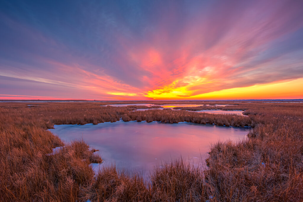 Bright pastel winter sunset over Cedar Run Dock Road salt marsh. Photographed at 14mm with seven bracketed exposures merged for HDR.